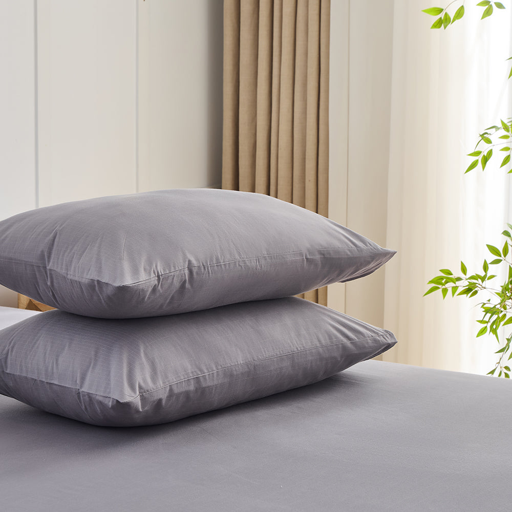 Earth grey organic grounding pillowcases set stacked on bed – Terra Solum luxury earthing bedding