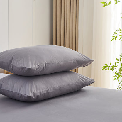 Earth grey organic grounding pillowcases set stacked on bed – Terra Solum luxury earthing bedding