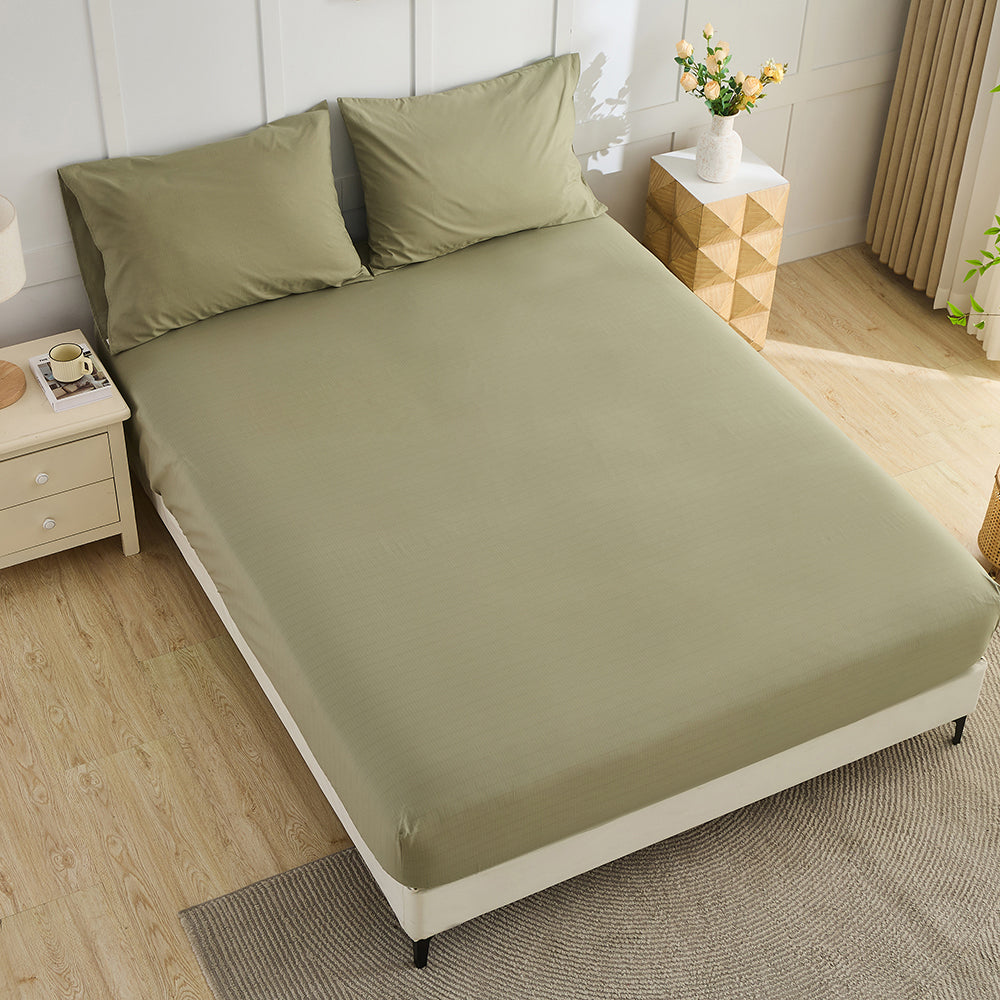 Olive green organic grounding fitted sheet on bed – luxury earthing bedding by Terra Solum