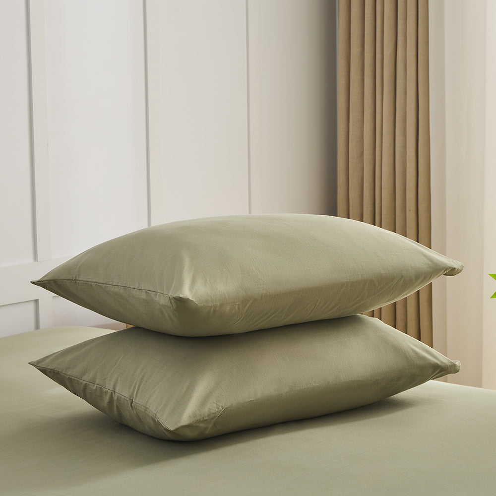 Olive green organic grounding pillowcases set stacked on bed – Terra Solum luxury earthing bedding