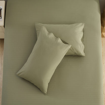 Olive green pillowcases styled in natural light bedroom – organic grounding bedding by Terra Solum